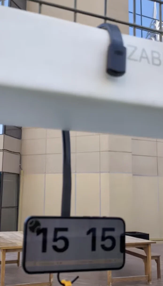 Phone mounted on side of court
